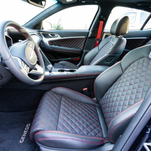 Genesis G70 3.3t photographed from the driver side showing the interior and the front seat.