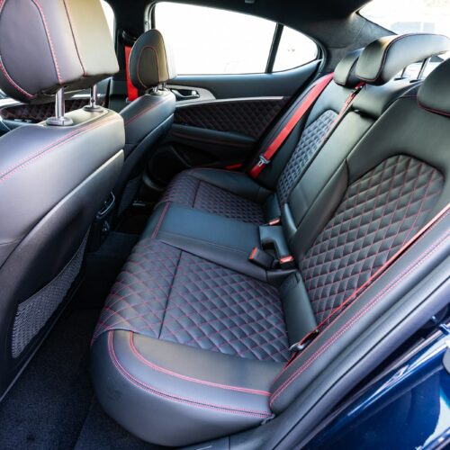 Genesis G70 3.3t photographed from the driver side showing the interior and the rear seat.