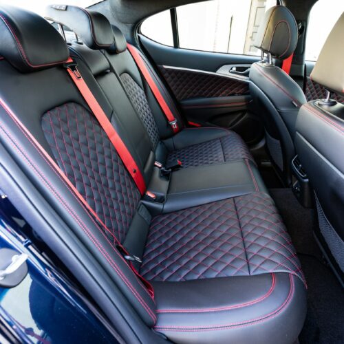 Genesis G70 3.3t photographed from the passenger side showing the interior and the rear seat.