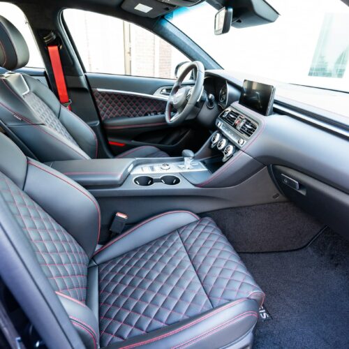 Genesis G70 3.3t photographed from the passenger side showing the interior and the front seat.