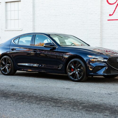 Genesis G70 3.3t parked street side by Mac's Chophouse in Marietta Square photographed from the passenger side front quarter panel.