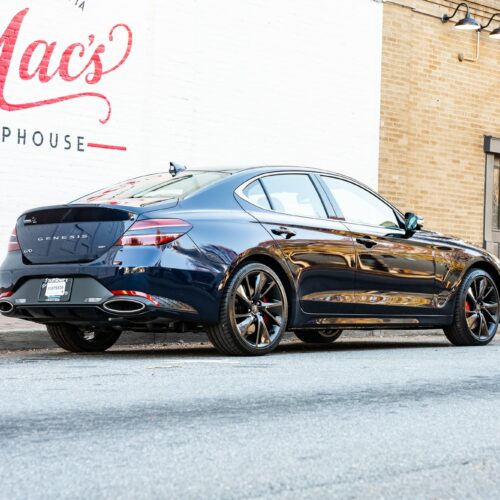 Genesis G70 3.3t parked street side by Mac's Chophouse in Marietta Square photographed from the passenger side rear quarter panel.