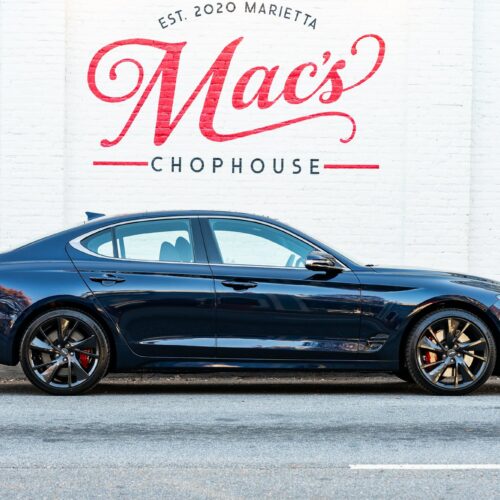 Genesis G70 3.3t parked street side by Mac's Chophouse in Marietta Square photographed from the passenger side.