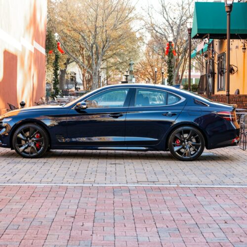 Genesis G70 3.3t in a colorful alley in Marietta Square photographed from the driver side.