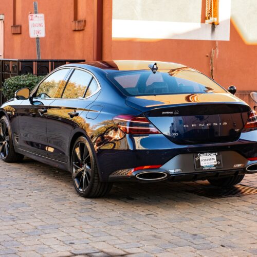 Genesis G70 3.3t in a colorful alley in Marietta Square photographed from the driver side rear quarter panel.