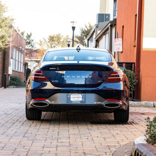 Genesis G70 3.3t in a colorful alley in Marietta Square photographed from the rear.