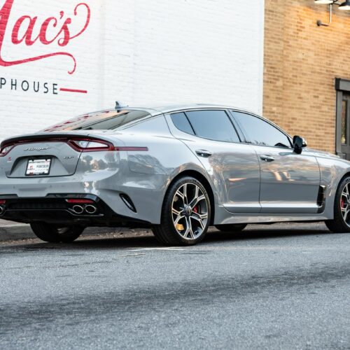 Kia Stinger parked street side by Mac's Chophouse in Marietta Square photographed from the passenger side rear quarter panel.