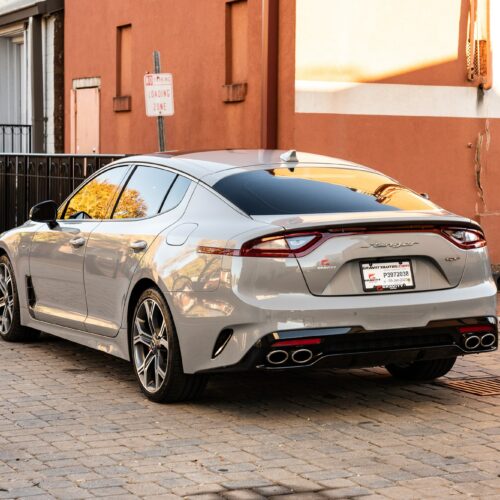 Kia Stinger in a colorful alley in Marietta Square photographed from the driver side rear quarter panel.