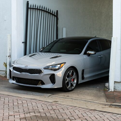 Kia Stinger in a colorful alley in Marietta Square photographed from the driver side front quarter panel.