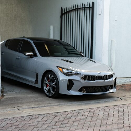 Kia Stinger in a colorful alley in Marietta Square photographed from the passenger side front quarter panel.