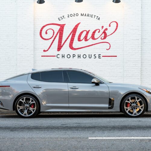 Kia Stinger parked street side by Mac's Chophouse in Marietta Square photographed from the passenger.