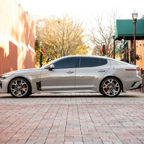 Kia Stinger in a colorful alley in Marietta Square photographed from the driver side.