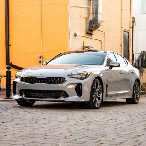 Kia Stinger in a colorful alley in Marietta Square photographed from the driver side front quarter panel.