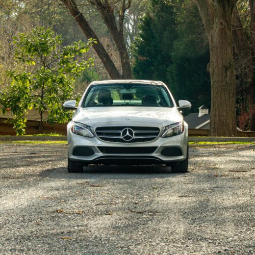 Mercedes C-Class parked in a lot photographed from the front.