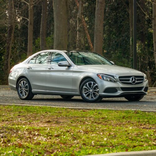 Mercedes C-Class parked in a lot photographed from the passenger side front quarter panel.