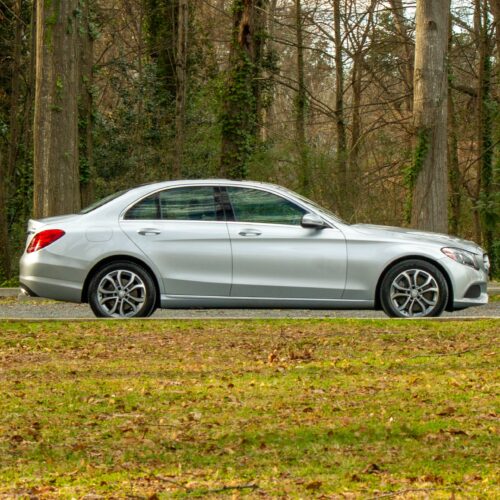 Mercedes C-Class parked in a lot photographed from the passenger side.